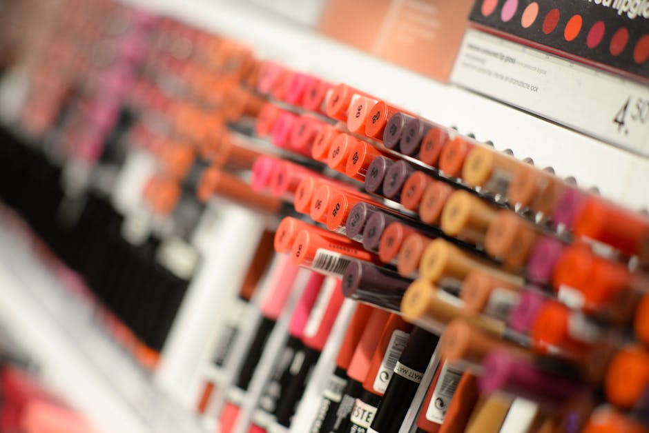 Close-up of diverse lipsticks in a store showcasing various shades and brands for beauty enthusiasts.